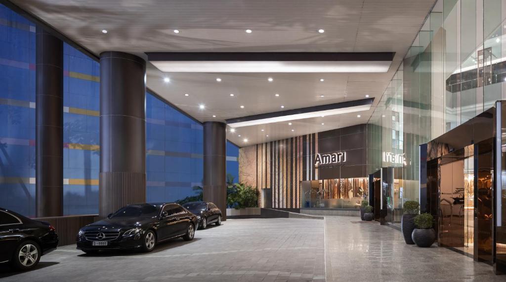 two cars parked in a parking lot in a building at Amari Bangkok in Bangkok