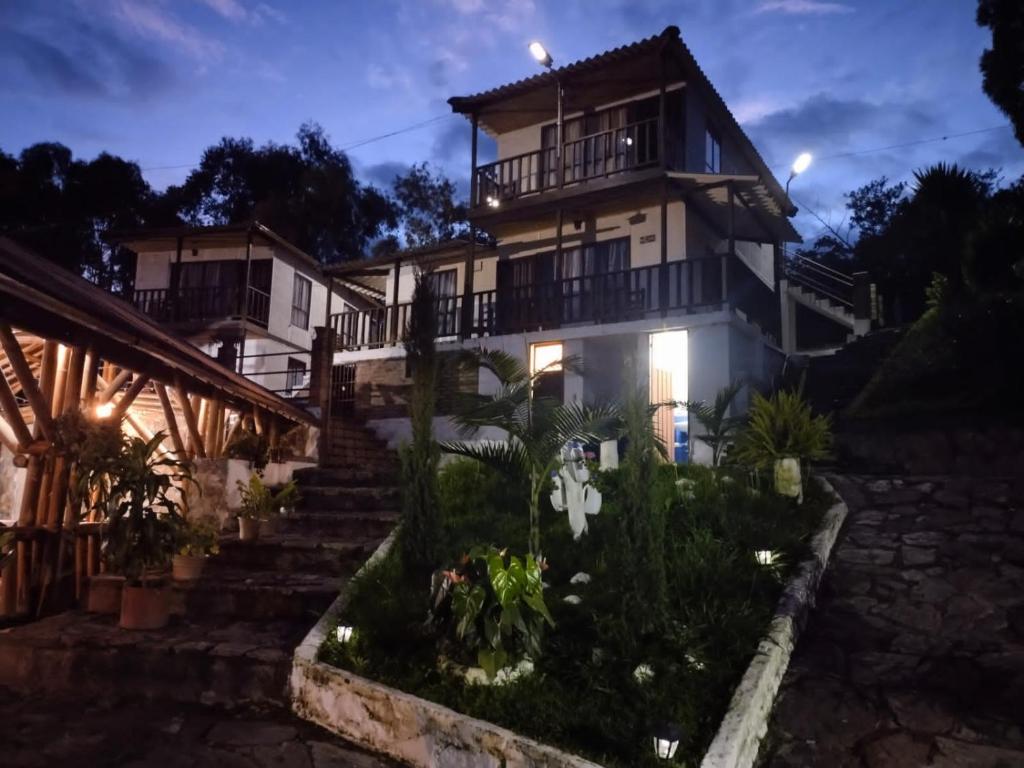 a house with stairs leading up to it at night at Hotel Campestre Mirador De San Nicolas in Ubaque