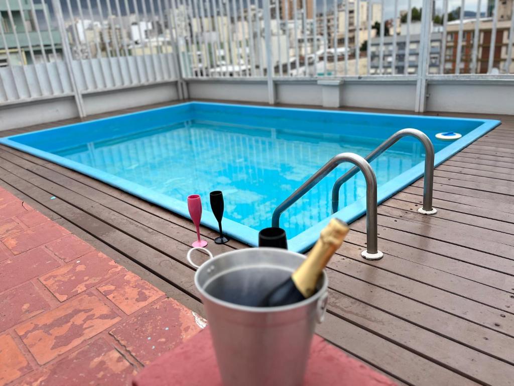 a swimming pool on the roof of a building at Flat em frente ao Cais Embarcadeiro in Porto Alegre