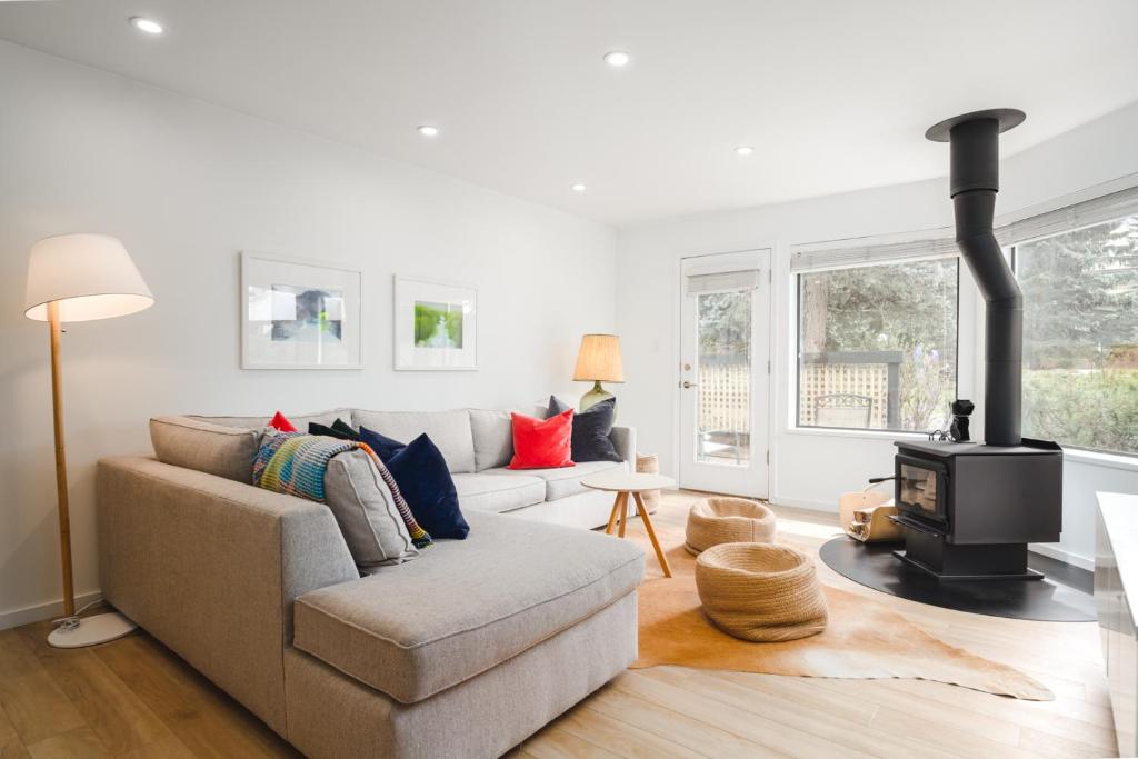 a living room with a couch and a wood stove at The Blackcomb Ski-In Getaway in Whistler