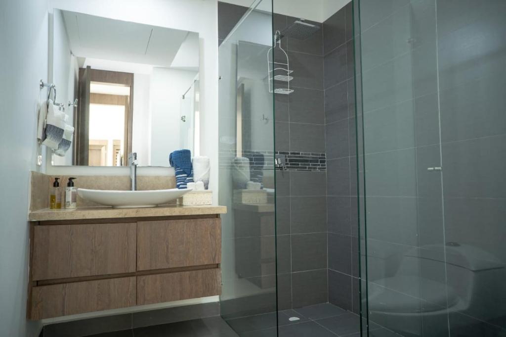 a bathroom with a sink and a glass shower at Apartment With natural view in Cartagena de Indias