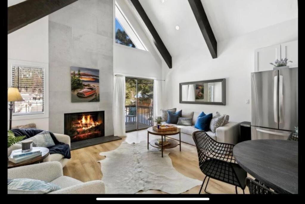 a living room with a fireplace and a table at Tahoe Haven: Your Retreat Awaits in Incline Village