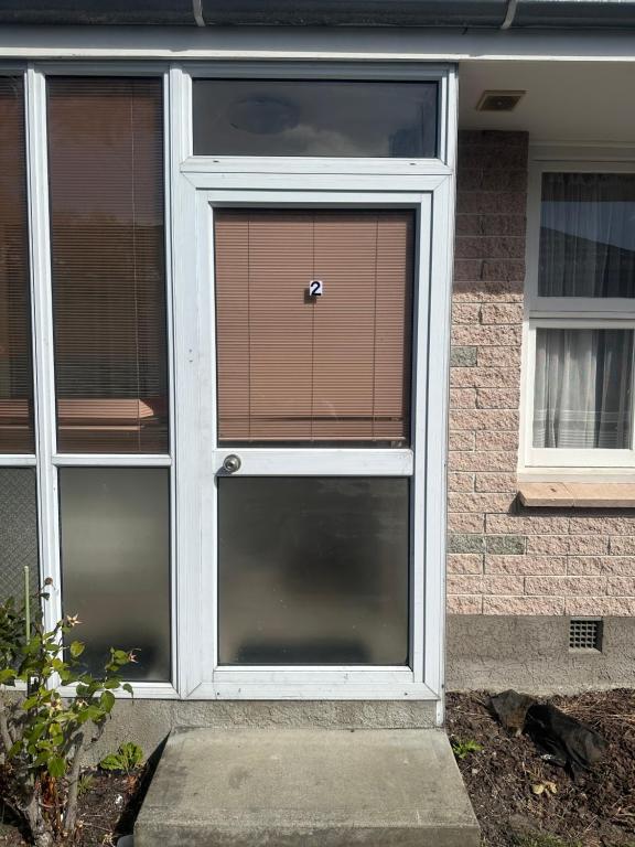 a front door of a house with a window at One bedroom entire unit in Christchurch