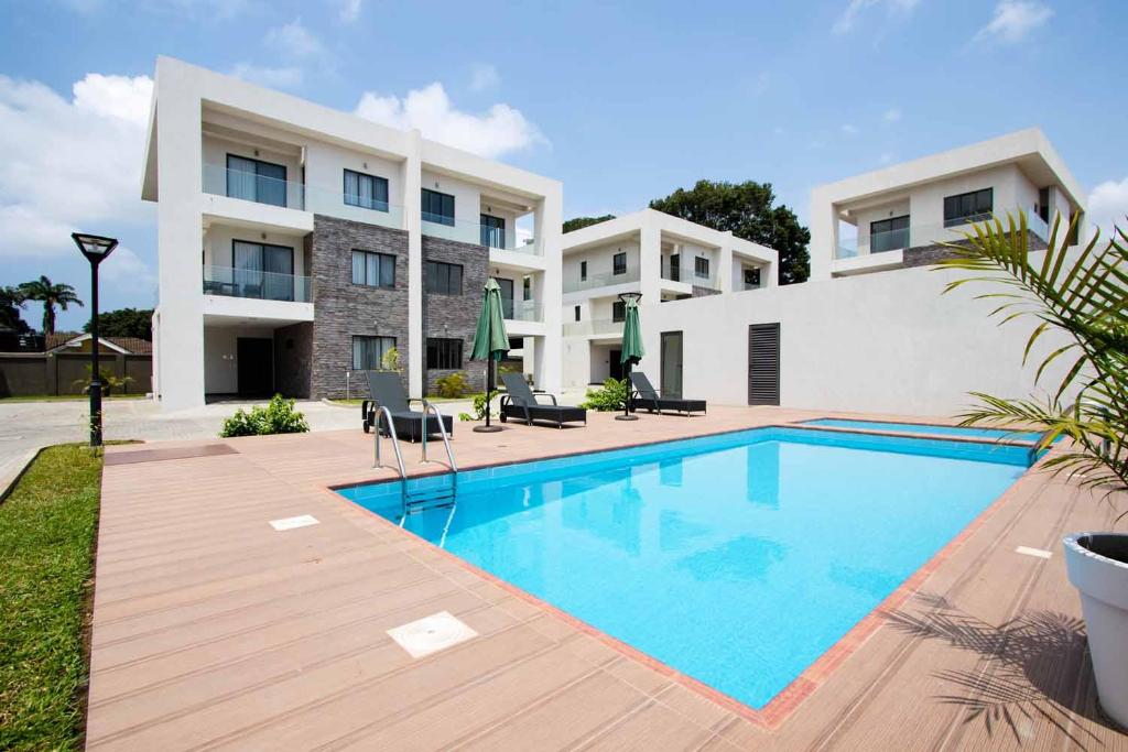 a swimming pool in front of a building at Stay Play Away Residences - Luxury 5 bed, Airport Residential in Accra