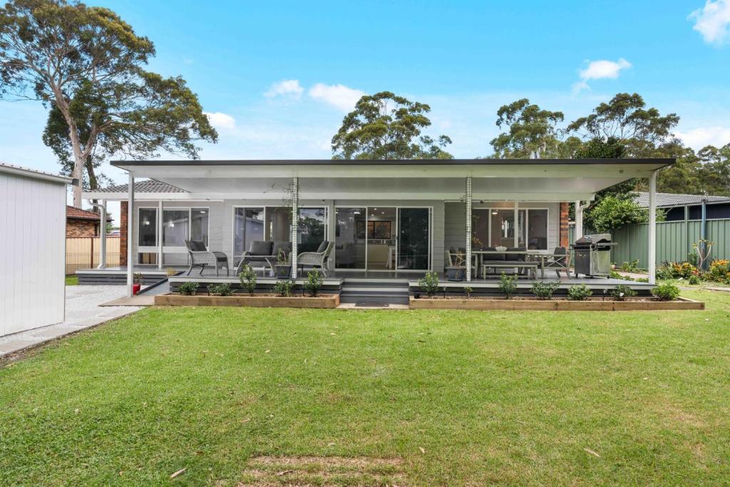 an image of a house with a lawn at The 19th Hole by Experience Jervis Bay in Sanctuary Point