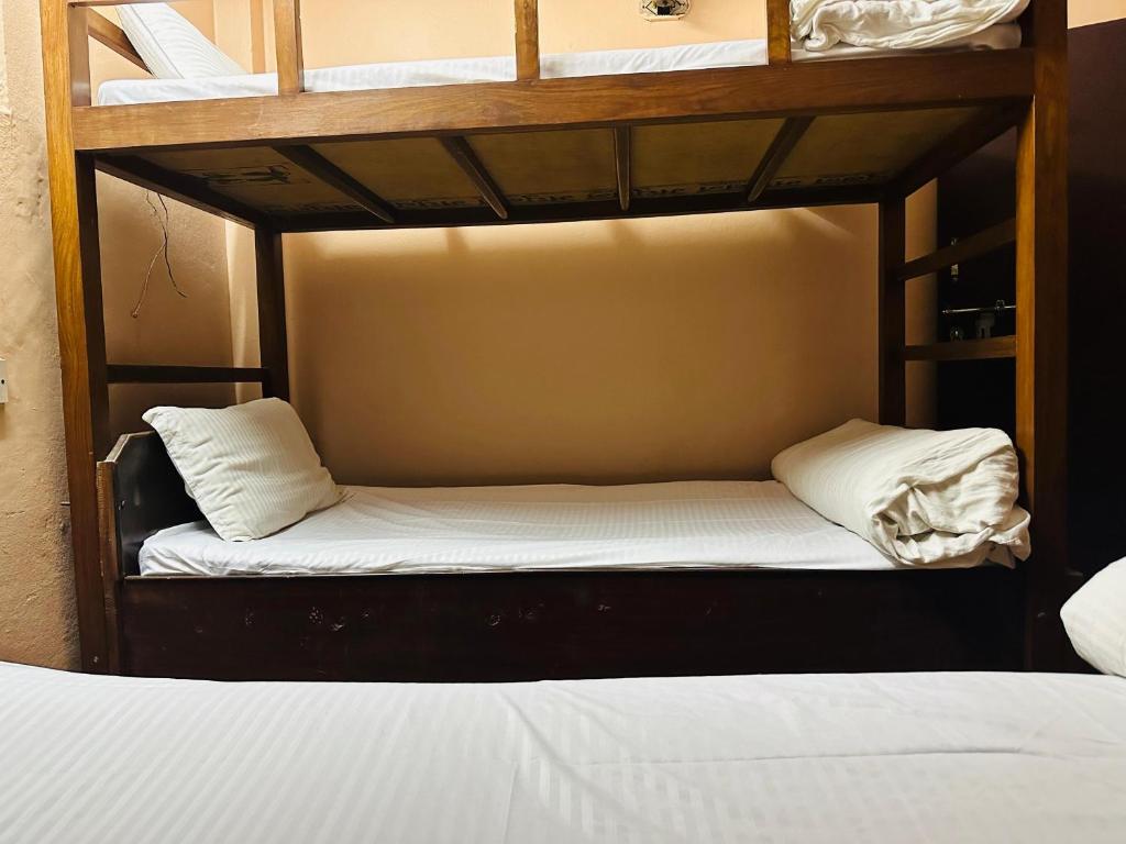 Postel nebo postele na pokoji v ubytování Hotel Travelers Home