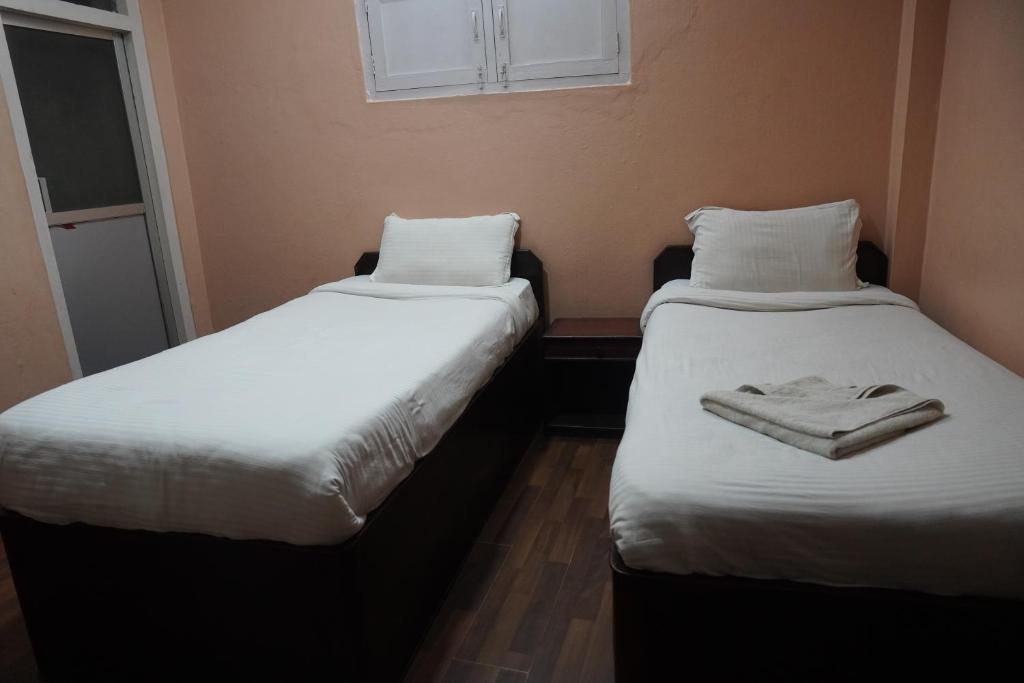 Postel nebo postele na pokoji v ubytování Hotel Travelers Home