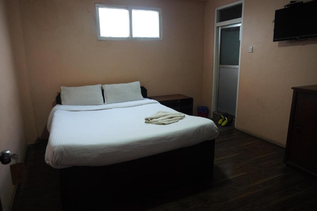 Postel nebo postele na pokoji v ubytování Hotel Travelers Home