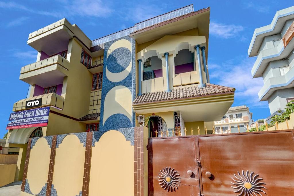 a building with a painting on the side of it at OYO Flagship Magadh Guest House in Gaya