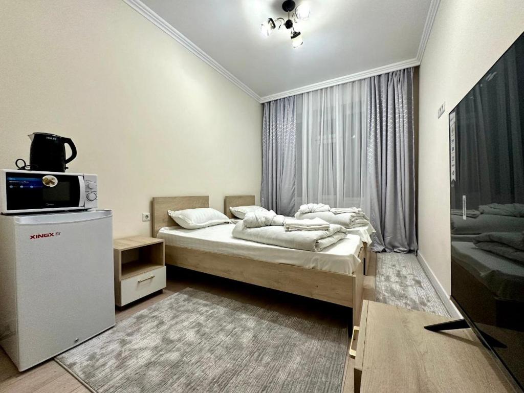 Postel nebo postele na pokoji v ubytování Ак-Бата