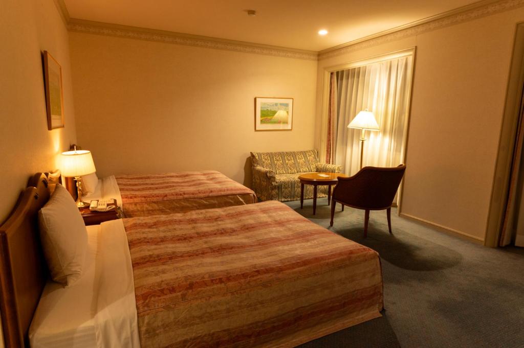 Postel nebo postele na pokoji v ubytování Fuji Classic Hotel