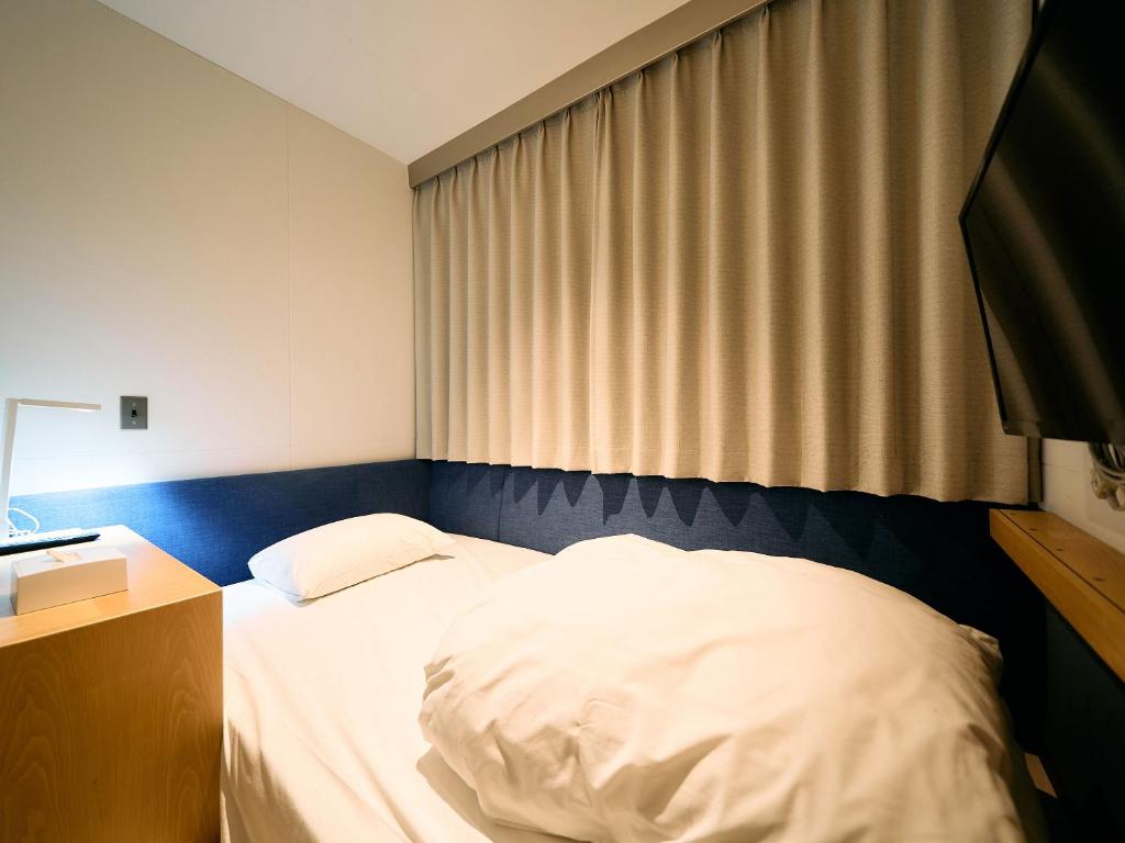 Postel nebo postele na pokoji v ubytování Hotel Plus Hostel TOKYO KAWASAKI