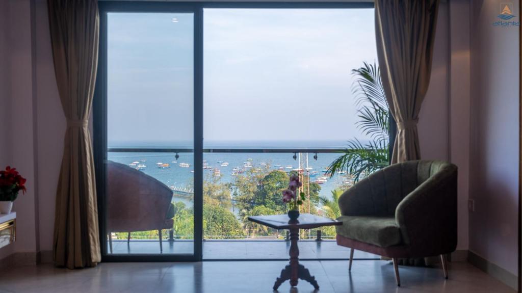 a living room with a view of the ocean at Hotel Atlanta - A Seaview Hotel in Port Blair