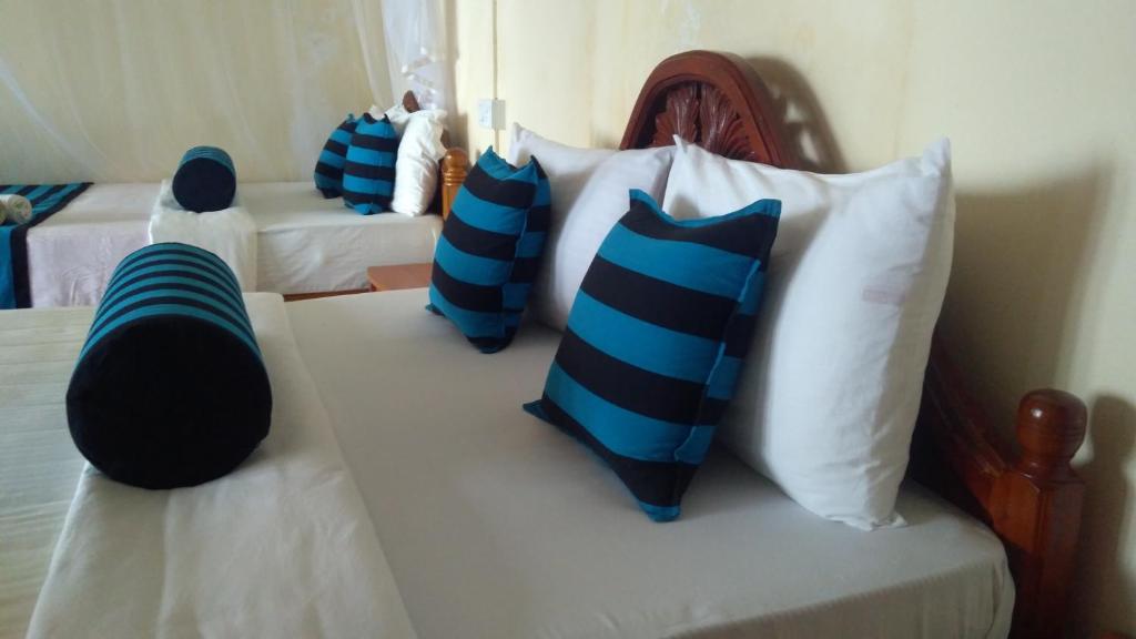 Postel nebo postele na pokoji v ubytování Blue Ribbon Homestay