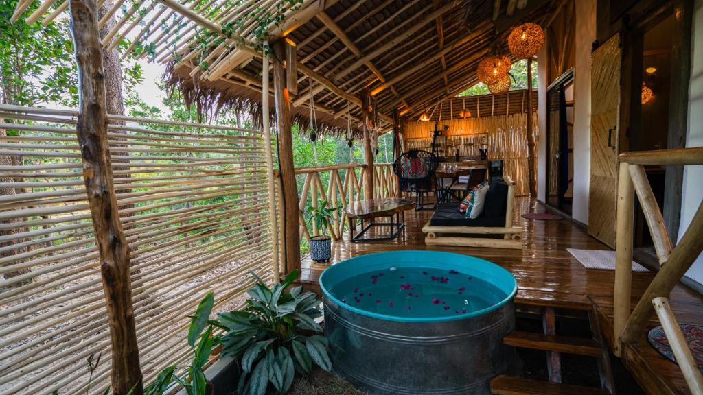 a room with a large tub in a house at Carabao Lodge - 2 bedroom house, stargazing & pool in El Nido