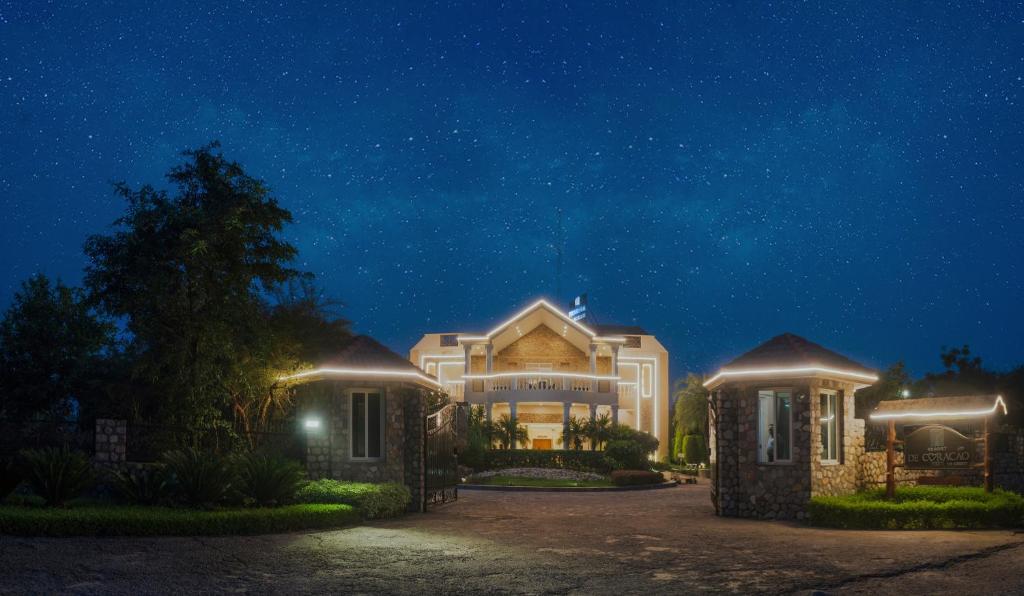 a large house at night with lights on at Resort De Coracao - Corbett , Uttarakhand in Rāmnagar
