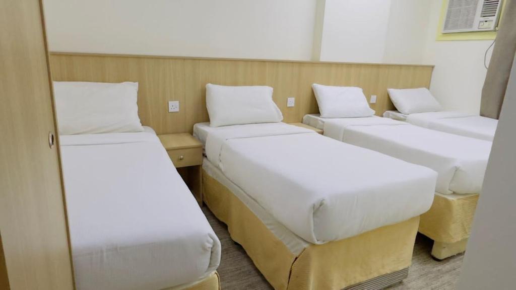 a row of beds in a room at فندق سما السماح Sama Al Samah Hotel in Makkah