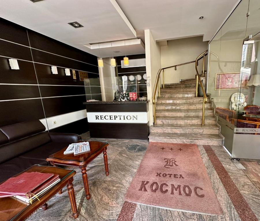 a living room with a couch and a staircase at Hotel Cosmos in Ruse