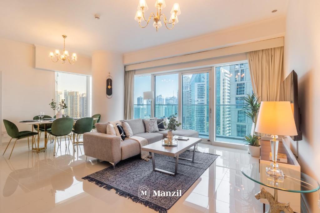 a living room with a couch and a table at Manzil - 2BR in Dubai Marina with Sea and Marina View in Dubai