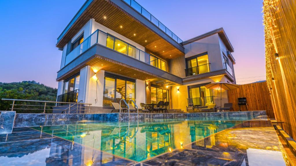 uma casa com piscina em frente a uma casa em Villa Myra Elite em Demre