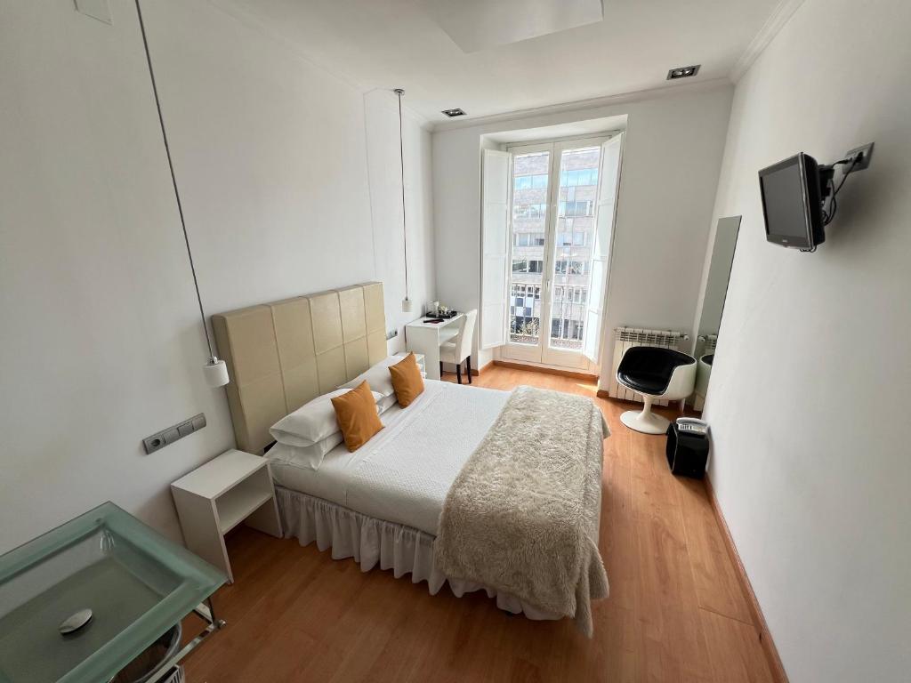 Postel nebo postele na pokoji v ubytování Hostal Santo Domingo
