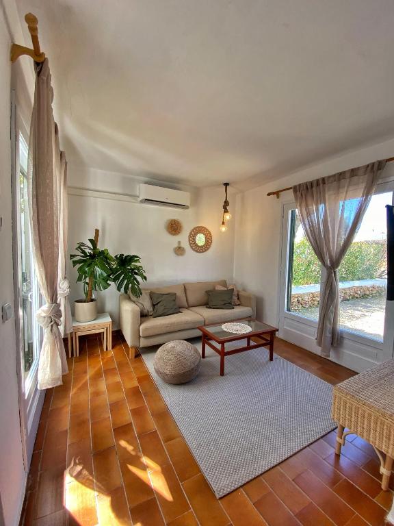a living room with a couch and a table at Villa Calma 450m from the beach in Cala en Blanes