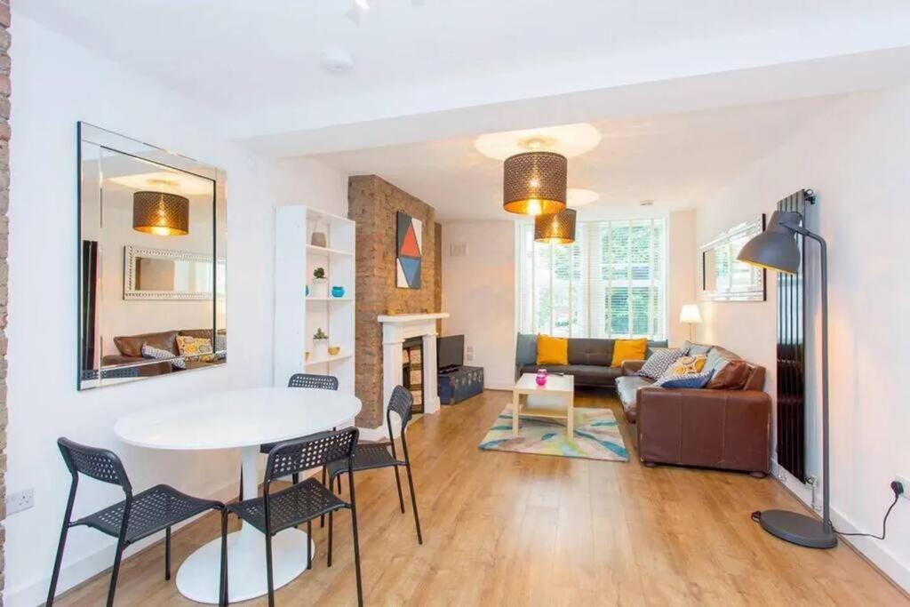 a living room with a table and chairs and a couch at Сharming & Peaceful 3BDR flat near Wembley station in London