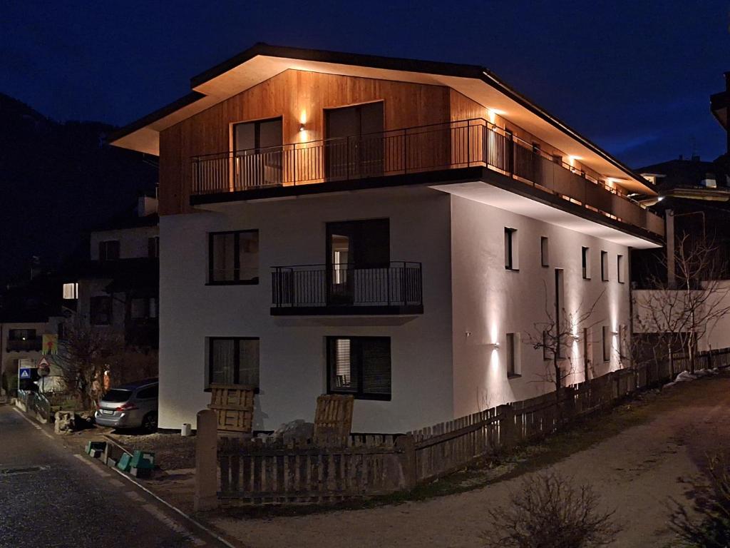 a white house with a balcony on the side of it at Chalet Center Pic in Ortisei