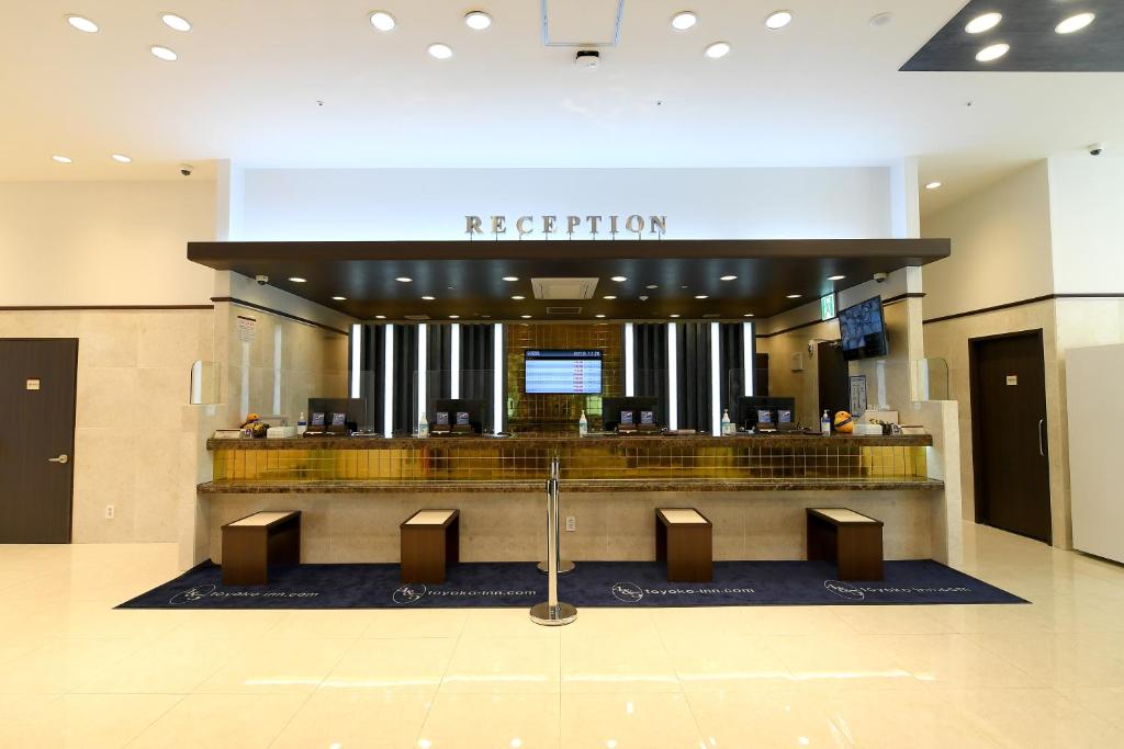 a hotel lobby with a reception desk in a building at Toyoko Inn Changwon in Changwon