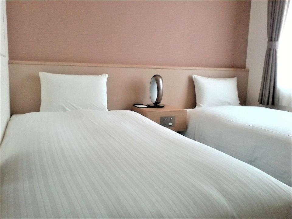Postel nebo postele na pokoji v ubytování Bande Hotel Osaka
