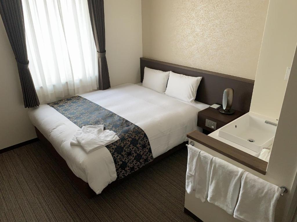 Postel nebo postele na pokoji v ubytování Bande Hotel Osaka