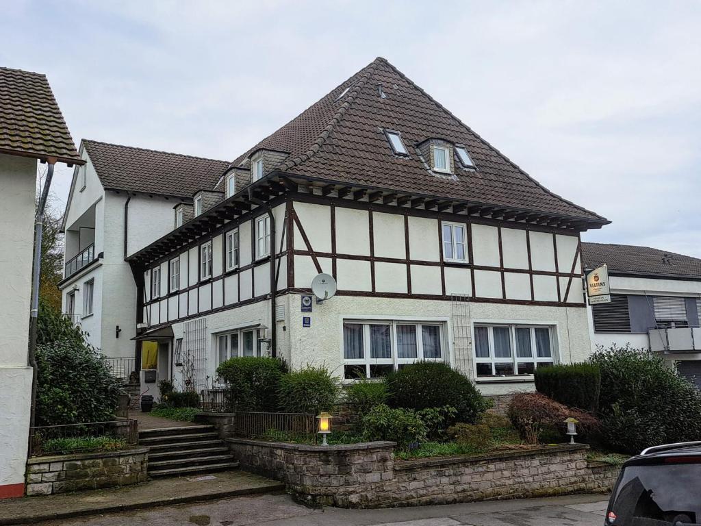 a large white house with a brown roof at Pension Waltermann in Balve