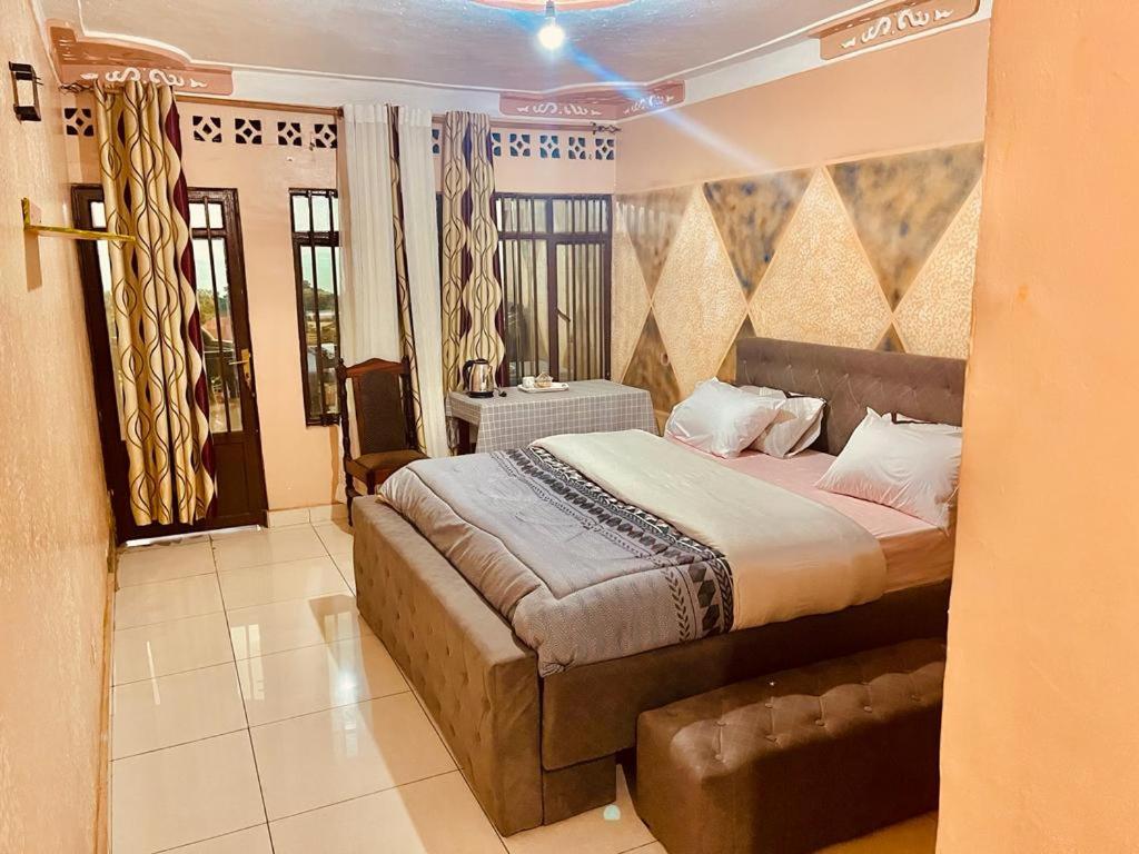a bedroom with a large bed in a room at Mont Carmel Hotel in Gisenyi