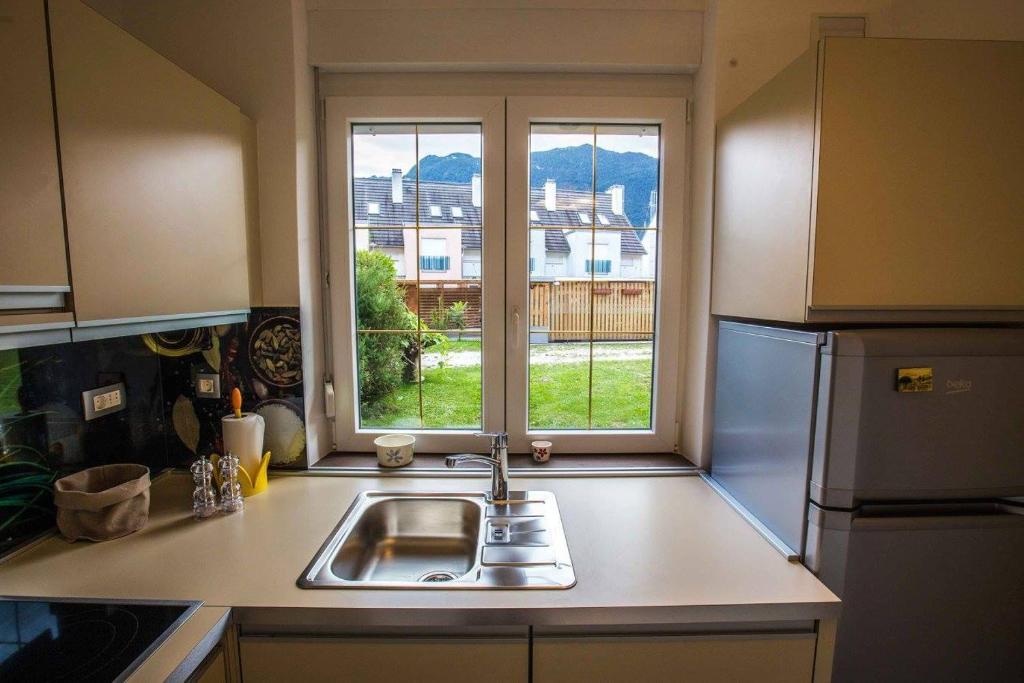 a kitchen with a sink and a window at Apartment ALBA in Bovec