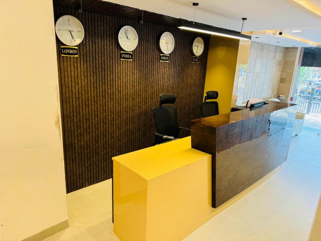 an office cubicle with clocks on the wall at Royal Plaza City in Kozhikode