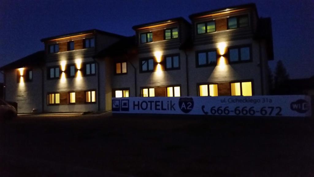 a building with its lights on at night at Hotelik A2 in Pruszków