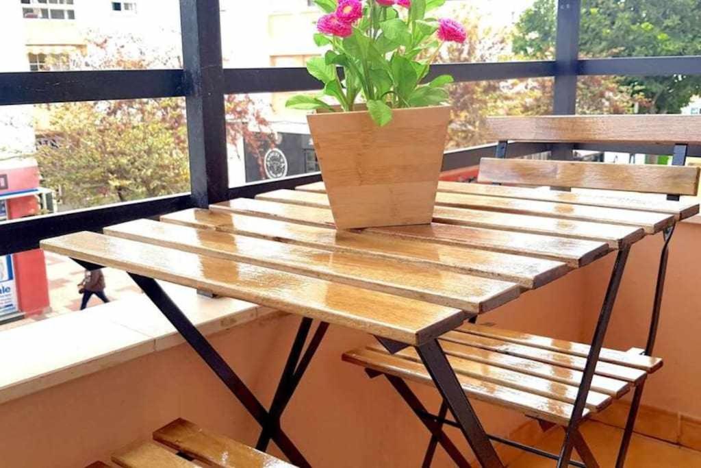 a wooden table with a potted plant on a window at NEPTUNO Estudio en el centro de Torremolinos in Torremolinos
