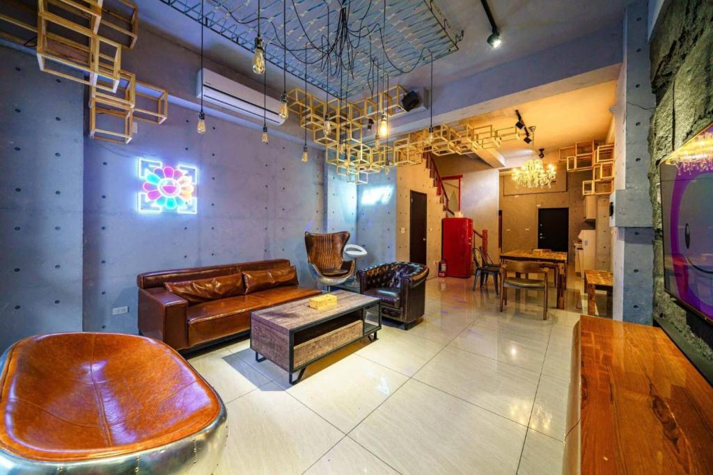 a living room with a couch and a table at Tainan Anping AP7 B&B in Anping