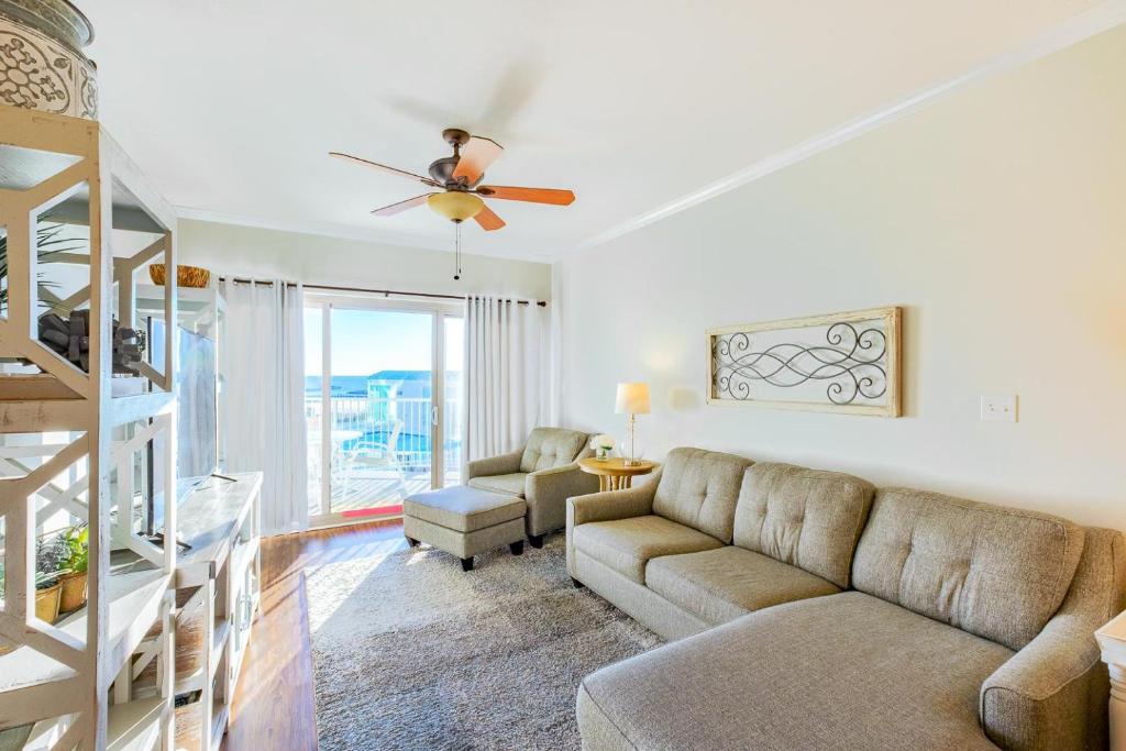 a living room with a couch and a ceiling fan at Sea Breeze 311 Deluxe in Biloxi
