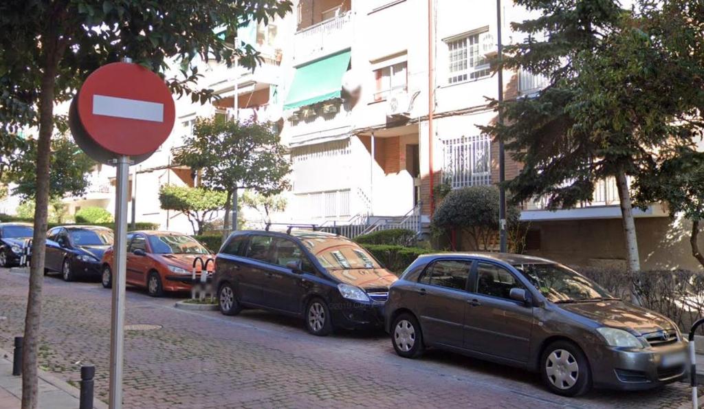 a group of cars parked on the side of a street at Golden line in Alcobendas