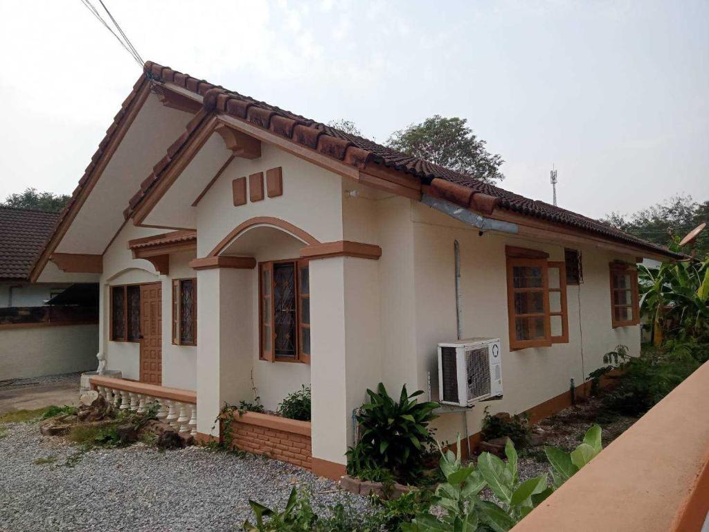 a small white house with at Bualuang Country Village - Pet Friendly in Uttaradit