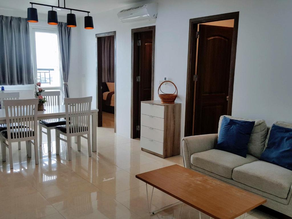 a living room with a couch and a table at 2-Bedroom Condo with City Skyline View in Vientiane