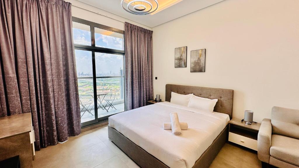 a bedroom with a bed and a large window at Luxury Studio Apartment Palm View with Big Balcony Free Parking by Belvilla in Dubai