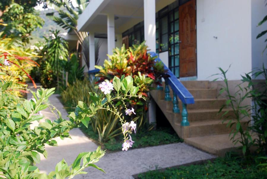 a house with a bunch of flowers on the stairs at Sea Sun Bungalow in Ko Lanta