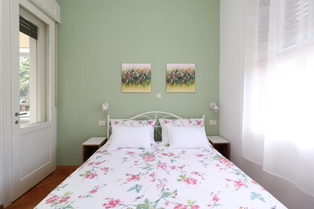 a bedroom with a bed with a floral bedspread at Apartment Anka in Opatija