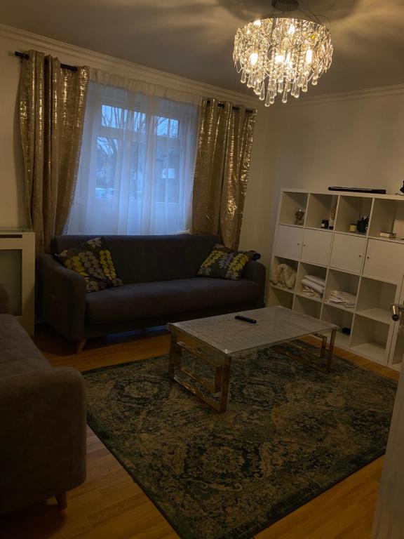 a living room with a couch and a coffee table at A modern flat in Southeast London in London