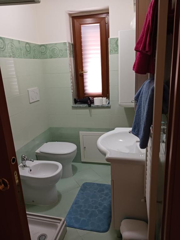 a bathroom with a toilet and a sink at Cappuccini Guest House in San Giovanni in Fiore