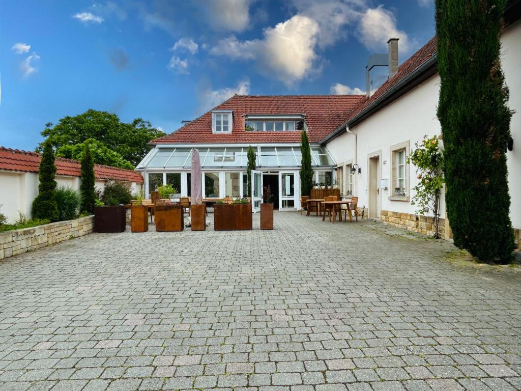 a house with a brick driveway in front of it at Schlosskoje - Ihr FerienZuhause in der Pfalz in Neustadt an der Weinstraße