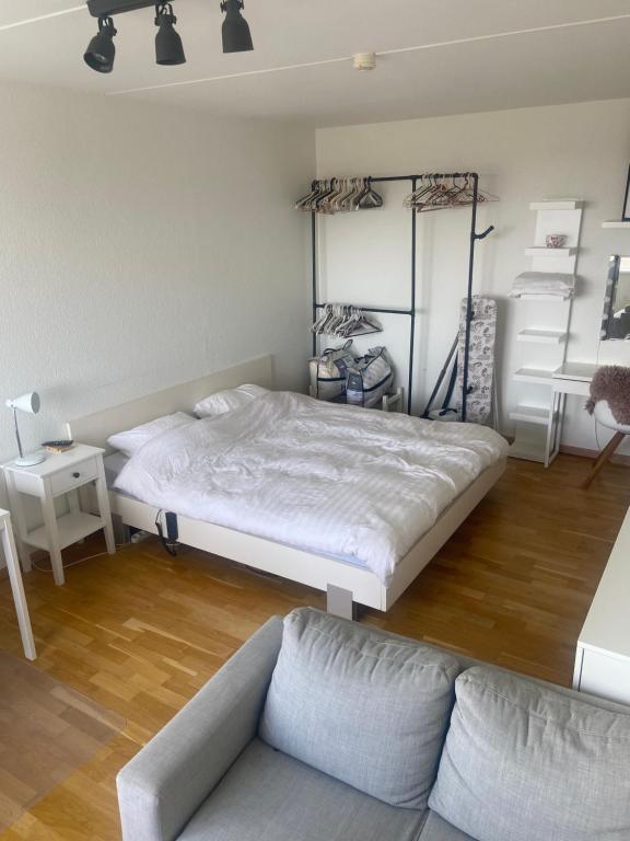 a bedroom with a large bed and a couch at Studio apartment in Copenhagen. in Copenhagen