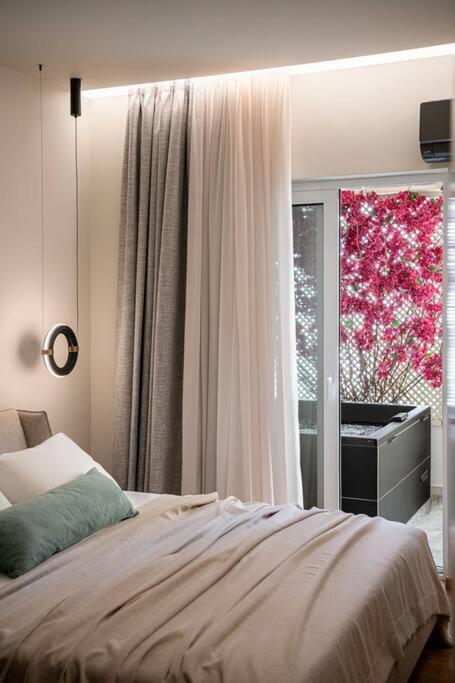 a bedroom with a bed and a window with a piano at ElKorin Jacuzzi Luxury Living in Chania
